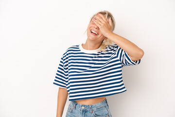 Young Russian woman isolated on white background covers eyes with hands, smiles broadly waiting for a surprise.