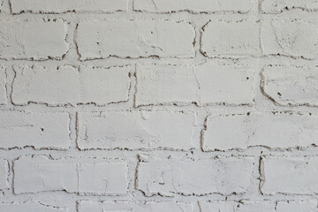 Obraz premium Decorative plaster on the wall in the form of white brickwork close-up
