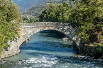 Stone bridge over the Dora Baltea river in Saint Marcel, Aosta Valley, Italy