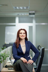 Successful smiling adult businesswoman portrait at the office.