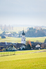 Austrian mountain village with misty valley background during autumn in Wildermieming, Tirol, Austria