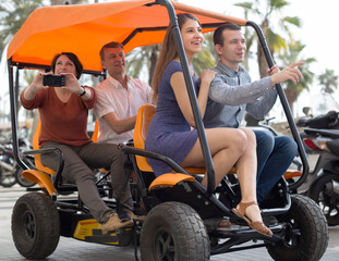 family of tourists enjoy a walk on the bike carriage