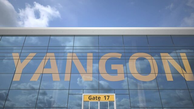 YANGON text revealed with landing airplane on airport building