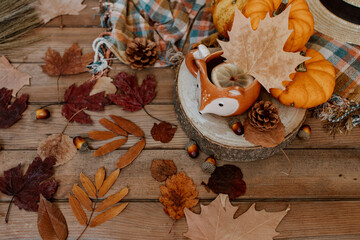 Autumn creative composition made of pumpkins, tea cup, dried leaves. Autumn, fall, halloween concept. Season background