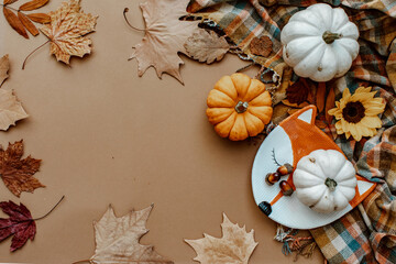 Autumn creative composition made of pumpkins, dried leaves. Autumn, fall, halloween concept. Flat lay, top view.