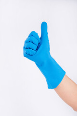 Hand showing a thumbs up in a blue washing up glove