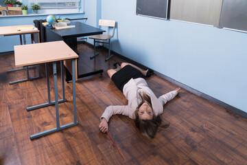 Crime scene (imitation). Strangled teacher in the classroom...