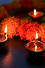Diwali celebration Indian festival of lights Diya oil lamp and colors Rangoli decoration bright colorful  flowers flowerbed copy space greetings Dipavali Hindu festival North India, Mumbai Delhi India © sanirimpan