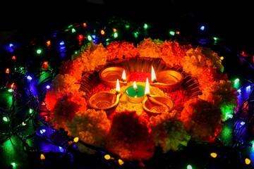 Diwali celebration Indian festival of lights Diya oil lamp and colors Rangoli decoration bright colorful  flowers flowerbed copy space greetings Dipavali Hindu festival North India, Mumbai Delhi India