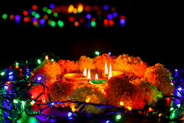 Diwali celebration Indian festival of lights Diya oil lamp and colors Rangoli decoration bright colorful  flowers flowerbed copy space greetings Dipavali Hindu festival North India Mumbai Delhi India