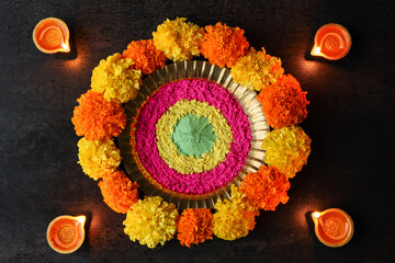 Diwali celebration Indian festival of lights Diya oil lamp and colors Rangoli decoration bright colorful  flowers flowerbed copy space greetings Dipavali Hindu festival North India, Mumbai Delhi India