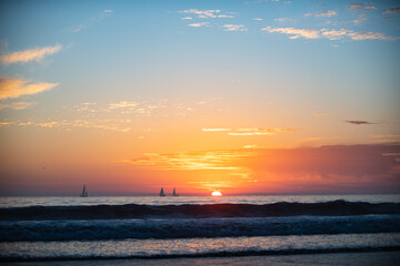 Sunrise over the sea and beautiful cloudscape. Colorful ocean beach sunset.