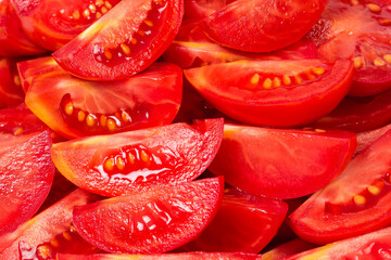 Heap of pieces of the red tomatoes close-up