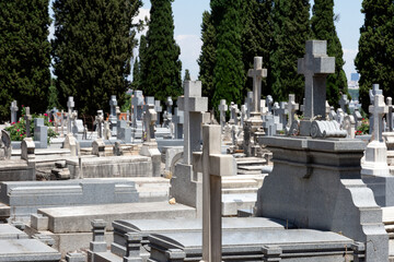 View of marble and stone crosses and tombs in a cemetery