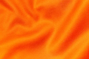 Plexiglas foto achterwand Orange color sports clothing fabric football shirt jersey texture and textile background © Southtownboy Studio