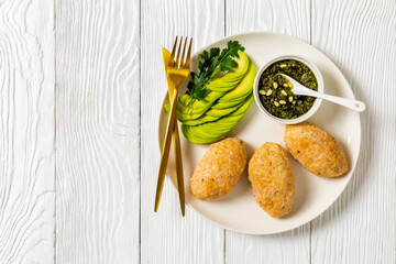 Baked white fish cakes with avocado and sauce