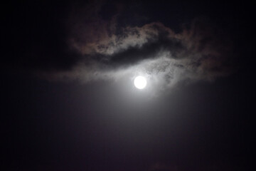 Fototapeta na wymiar Moon shining in dark night sky
