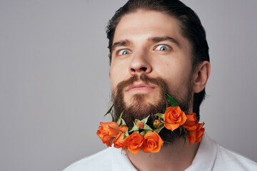 man in a white shirt flowers in a beard attractive look jewelry