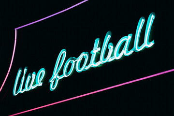 Neon signboard of live football in pub