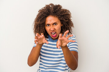 Young african american woman with curly hair isolated on white background upset screaming with...