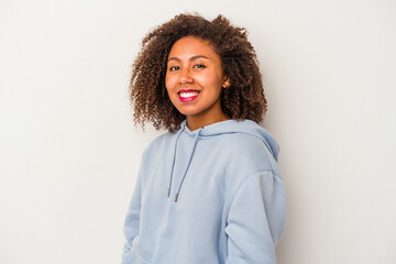 Young african american woman with curly hair isolated on white background confident keeping hands on hips.