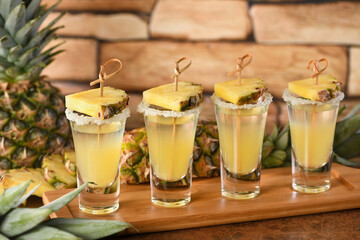  Double shots of tropical tequila with pineapple juice. This is definitely going to be a great party for Cinco de Mayo! - obrazy, fototapety, plakaty