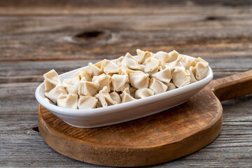 frozen ravioli on wood background. Mediterranean cuisine delicacies