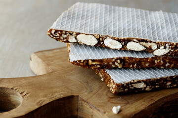 Turron nougat dessert with almond nuts and sesame seeds with honey close-up.