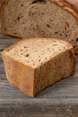 Organic sourdough bread on wood background.