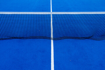 Net of a blue synthetic grass paddle tennis court