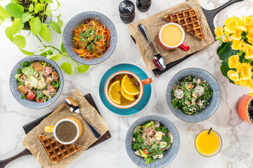 Breakfast food table brunch set with freah salad and waffle on marble background