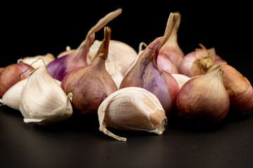 Whole group pile ingredient of fresh onion garlic group isolated on black background