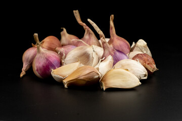 Whole group pile ingredient of fresh onion garlic group isolated on black background