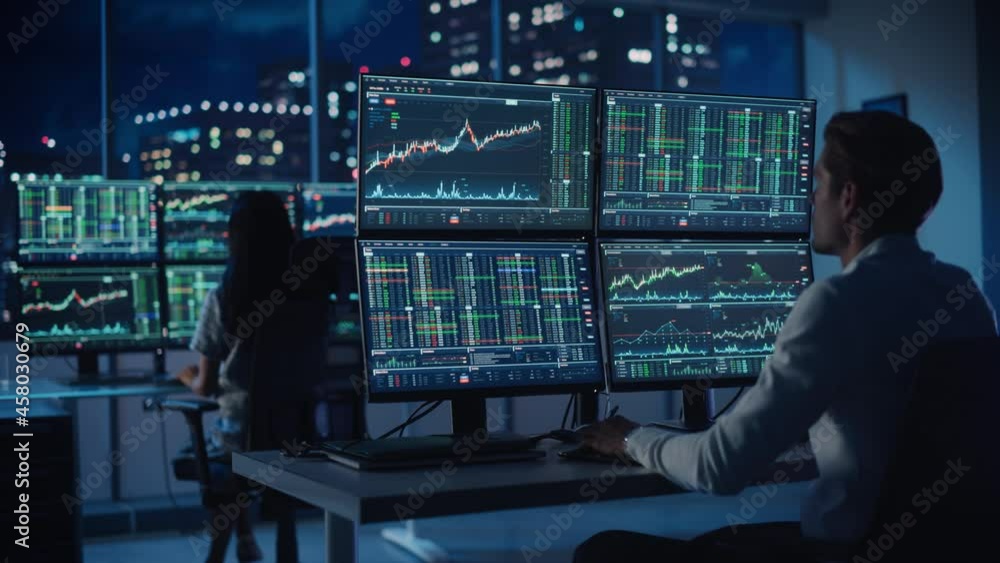 Poster financial analyst working on a computer with multi-monitor workstation with real-time stocks, commod