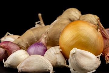 Whole group pile ingredient of fresh onion garlic ginger group isolated on black background