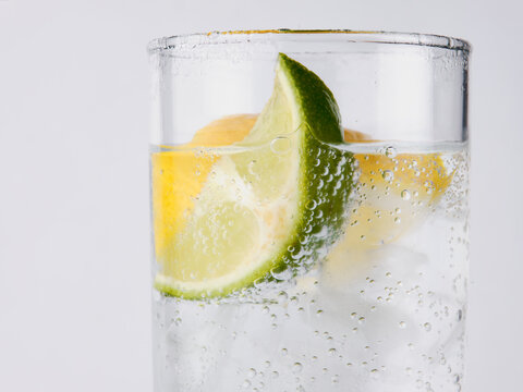 Seltzer water with lime and lemon wedge