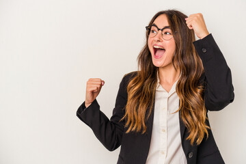 Young caucasian business woman isolated on white background raising fist after a victory, winner concept.