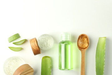 Aloe vera cosmetics, leaves and slices on white background