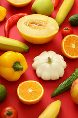 Set of different vegetables and fruits on red background