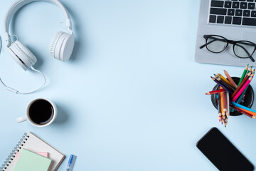 Online learning design concept. Top view of student table with computer, headphone and stationeries.