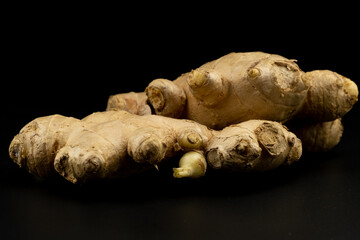 Whole group pile ingredient of fresh ginger group isolated on black background