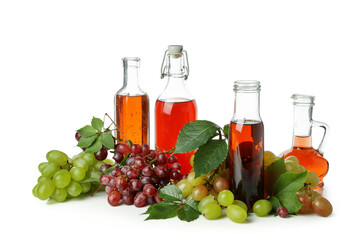 Bottles of vinegar and grape isolated on white background