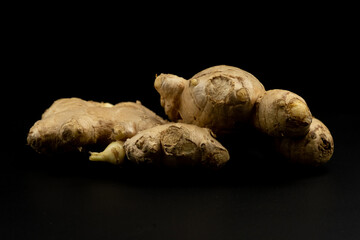 Whole group pile ingredient of fresh ginger group isolated on black background