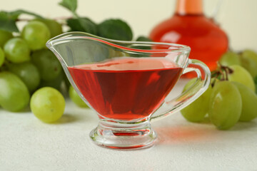 Concept of grape vinegar on white textured table