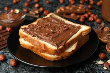 Concept of delicious food with chocolate paste on black smokey background