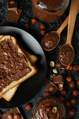 Concept of delicious food with chocolate paste on black smokey background