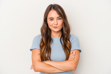 Young caucasian woman isolated on white background frowning face in displeasure, keeps arms folded.