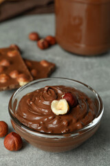 Concept of delicious food with chocolate paste on gray textured table