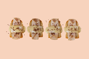 Toasted bread with ham, yellow cheese and flax seeds with a green, purple and blue background.