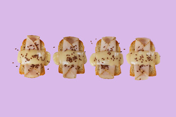 Toasted bread with ham, yellow cheese and flax seeds with a green, purple and blue background.